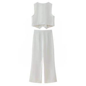 Detail of white two-piece set featuring a cropped vest top and high-waisted wide-leg pants