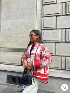 Detail of quilted cotton jacket with red toile de jouy pattern and kimono collar