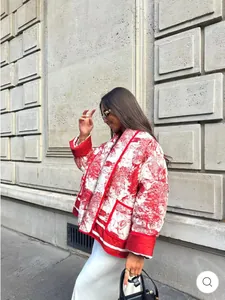 Close-up of quilted red and white Toile de Jouy print jacket with contrast piping