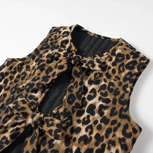 Detail of leopard print vest showing corduroy texture and elegant bow-tie ribbons
