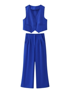 Detail of royal blue v-neck vest and matching high-waisted wide-leg trousers set