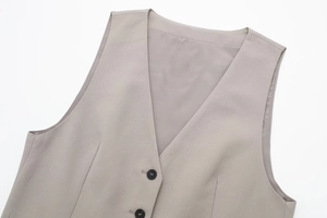 Close-up of light grey V-neck vest top with dual matte buttons and refined fabric texture