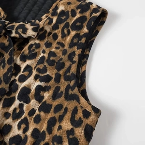 Women's leopard print corduroy vest with black quilted lining and bow tie detail