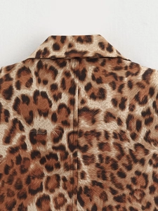 Close-up of leopard print top showing the shirt collar and fine stitching details