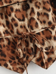 Detailed macro view of leopard print woven fabric and the waist tie-knot design