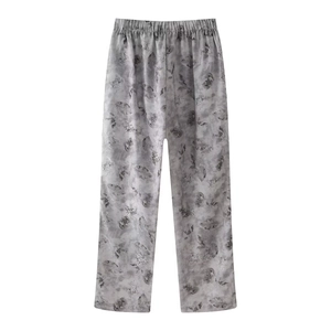 Detail of grey leaf print wide-leg trousers with an elasticated waistband and artistic design