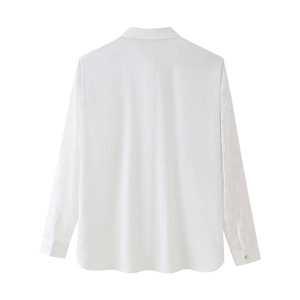 Women's white linen shirt with intricate floral embroidery on long sleeves, back view