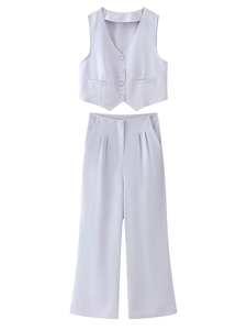 Detail of grey V-neck vest and high-waisted wide-leg trousers two-piece set