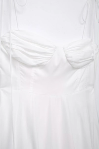 Detail of sweetheart neckline and pleated poplin fabric on this white summer dress