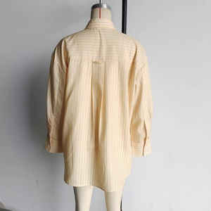 Detail view of the yellow striped shirt back featuring a classic center box pleat design