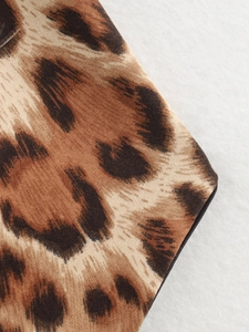 Macro shot of leopard print fabric texture and fine twill weaving on summer top
