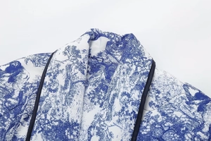 Detail of quilted cotton jacket with blue Toile de Jouy print and navy contrast piping
