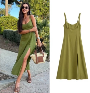 Detail of olive green linen maxi dress featuring thin straps and high side slits for summer