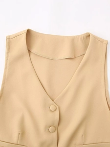 Detail of beige V-neck vest showing fabric texture and matching single-breasted buttons