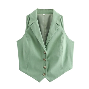 Detail of light green vest showing four tortoiseshell buttons and V-shaped hemline