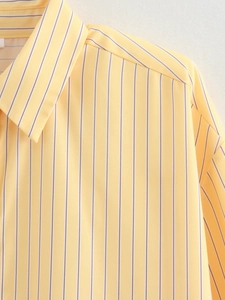 Detail of classic yellow and white vertical stripes on a soft casual cotton shirt
