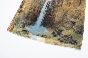 Detail of digital waterfall landscape print on slim fit mesh dress fabric texture