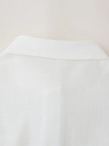 Detailed macro view of white linen shirt collar and back yoke texture with neat stitching