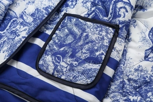 Detail of blue and white Toile de Jouy print jacket with quilted texture and pocket