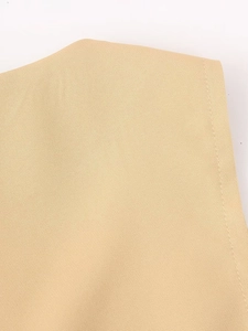Detail view of the fine stitching and textured blend fabric of a beige vest set