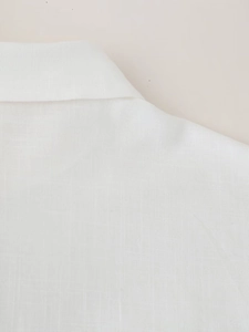 Macro detail of breathable white linen fabric and high-quality stitching on the shirt collar