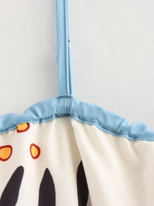 Detail of light blue spaghetti strap and stitching on abstract floral print summer dress
