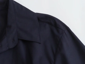 Detail of navy blue poplin shirt showing lapel collar and shoulder seam construction