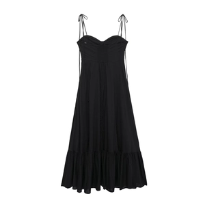 Close-up of black poplin dress featuring thin spaghetti straps and pleated bodice detail