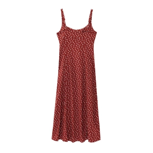 Detail of dark red polka dot maxi dress featuring thin straps and linen fabric