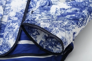 Detailed close-up of quilted floral Toile de Jouy jacket with striped lining and bound edges
