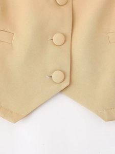 Detailed macro view of khaki vest fabric texture and matching fabric-covered button