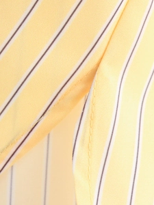 Close-up of the yellow and white striped fabric showing fine stitching and texture detail