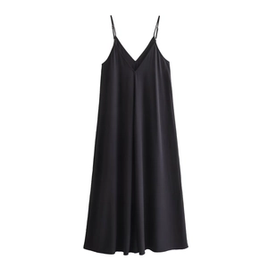 Detail of minimalist black V-neck slip dress showing smooth silky fabric and thin straps