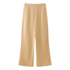 Detail of high-waist apricot wide-leg trousers with elegant drape and fine stitching