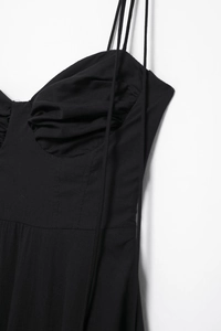 Detail of black poplin dress featuring ruched sweetheart neckline and slim shoulder straps