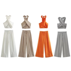 Flat lay of linen halter neck crop top and wide-leg trousers set in four neutral colors