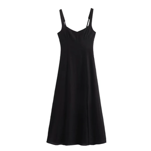 Detail of black linen strap dress with V-neckline and subtle pleated chest design