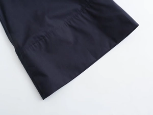 Detail of premium poplin fabric showing precise horizontal stitching on hemline
