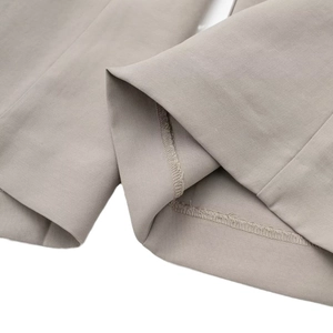 Detailed view of khaki slim fit vest and cargo pants with professional stitching and texture