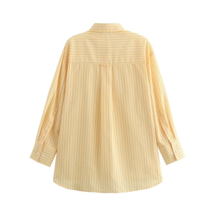 Close-up of yellow striped cotton shirt showing back pleat and fine fabric texture