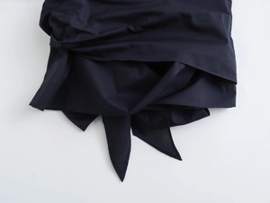 Detail view of navy cotton shirt hem with pleats and drawstring waist adjustment