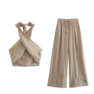Close-up of linen-textured halter top and drawstring wide-leg pants in beige set