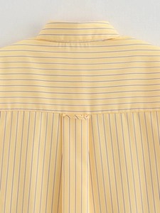 Detail of yellow striped shirt back yoke showing horizontal and vertical patterns