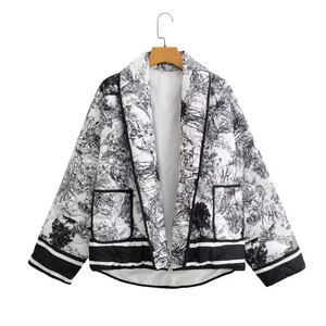 Close-up of Toile de Jouy print on women's quilted jacket with shawl collar and patch pockets
