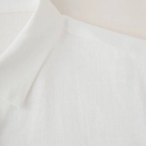 Women's white linen shirt with embroidered sleeves and clean textured fabric finish