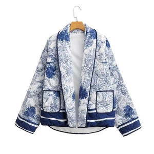 Detail view of quilted cotton jacket with blue toile de jouy print and large pockets