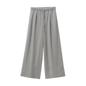 Detail of gray linen wide-leg trousers with elastic drawstring waist and hem stitching