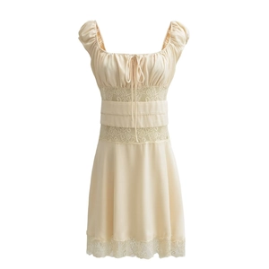 Detail view of cream vintage dress featuring intricate hollow lace trim and puff sleeves