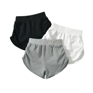 Detail of high waisted sports shorts with side ruching in black, white and grey colors