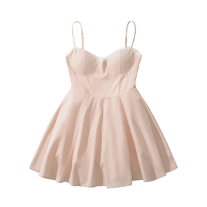 Detailed view of peach pink lace-trimmed neckline and padded cups on summer slip dress